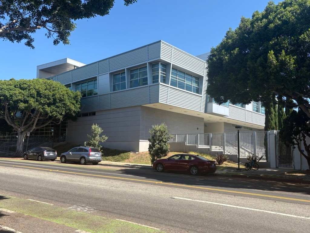 Modern institutional building framed by trees