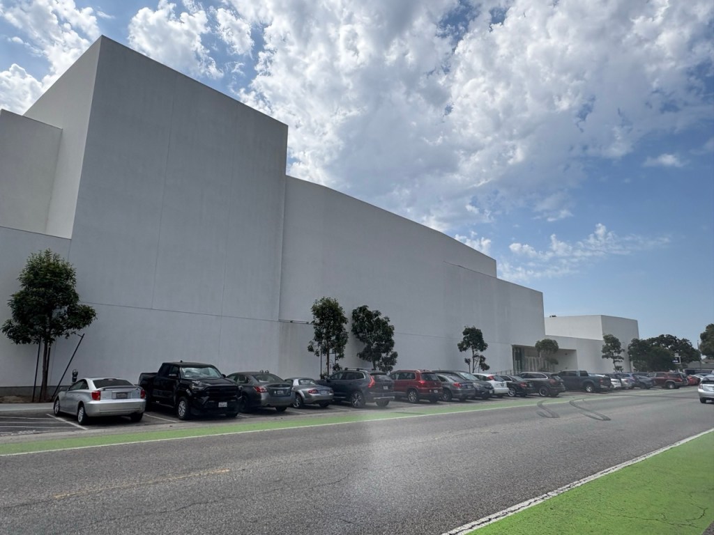 Large contemporary commercial building under a bright sky